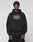 A person wears a black Live Fast Call Us Hooded by LIVE FAST DIE YOUNG, made of Baumwolle with BEACH VIEWS FOR FRIENDS +49-157-5666-3407 as bold front and back prints, standing against a plain light gray background.