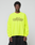 A person wears the LIVE FAST DIE YOUNG LFDY Real Est.8 Longsleeve in bright yellow, featuring bold "Approval GUARANTEED Credit Score Irrelevant" prints on front and back, against a plain light gray background. Made from 100% Baumwolle.