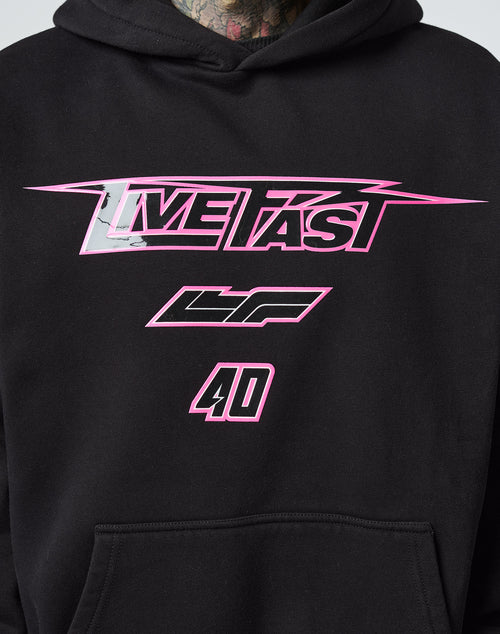 A close-up of the LFDY Triple Racing Hooded by LIVE FAST DIE YOUNG in black Baumwolle, Oversize Fit, with “LIVE FAST” in bold pink letters, “LF” below, and “40” at the bottom in a striking multilogo pink and white design.