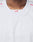 Close-up of a person wearing the Basic Mesh Jersey by LIVE FAST DIE YOUNG. This white oversize-fit sports jersey is made from 100% polyester with a V-neck collar. Red LFDY letters are visible inside the collar; face not shown.