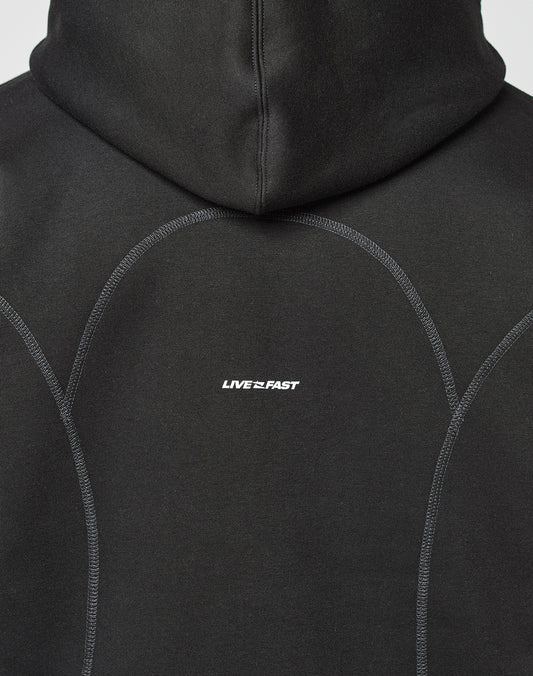 The back of the black LFDY Active Fleece Hooded Zip by LIVE FAST DIE YOUNG features an oversize fit, curved seams, a subtle logo, and LIVE FAST in small white letters at the center.