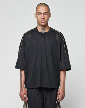 A person with closely shaved hair wears a LIVE FAST DIE YOUNG Basic Mesh Jersey and matching shorts with contrast piping, standing against a light gray background, facing forward with a neutral expression.