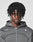 A young person with medium-dark skin and twist-styled hair faces the camera, wearing the LIVE FAST DIE YOUNG LFDY Active Fleece Hooded Zip in Oversize Fit with a white logo print on the chest, against a plain light background.