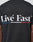 Back view of the Live Fast Paris Tee by LIVE FAST DIE YOUNG: black regular fit, “Livé Fast” in bold white letters above blue, white, and red stripes; 100% Baumwolle with front and back print details.