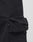 Close-up of a Wide Summer Cargo pant pocket by LIVE FAST DIE YOUNG, made from black ripstop fabric with a flap and small black tag on the side seam, shown against a plain light background.