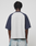 A person with short twisted hair is seen from the back, wearing the Live Fast Raglan Tee by LIVE FAST DIE YOUNG and light blue distressed jeans against a simple, light background.