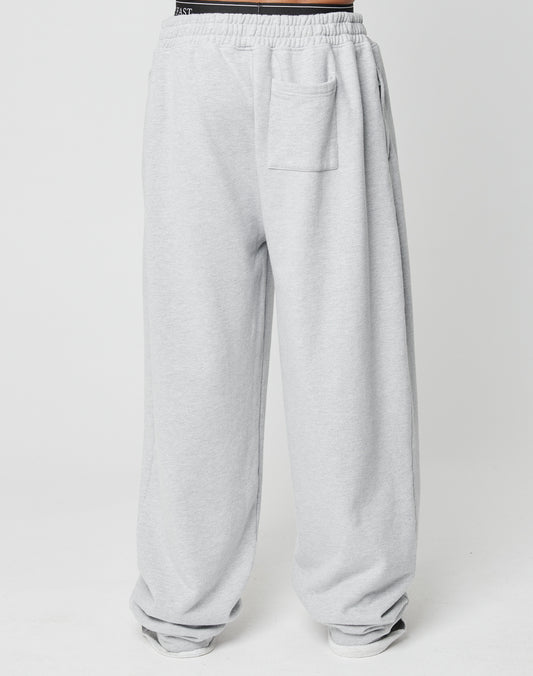 The Loyal Wide Jogger by LIVE FAST DIE YOUNG features an oversize fit, elastic waistband, side pockets, and a patch pocket on the front right thigh in light gray, displayed on a plain white background.