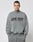 A man with short hair and neck tattoos models the LIVE FAST DIE YOUNG Live Fast Europe Run Sweater, a gray oversized sweatshirt with a bold front print, against a plain light background.