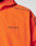 Close-up of the Live Fast Trackjacket by LIVE FAST DIE YOUNG, featuring bright orange Nylon-Elastan fabric with black piping and LIVE FAST printed in black on the chest. Only the upper torso and part of the shoulder are shown.