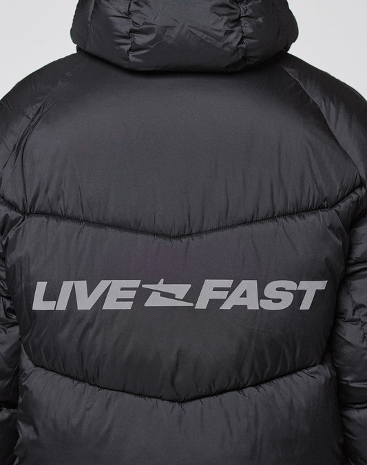A close-up of the Live Fast Puffer Jacket by LIVE FAST DIE YOUNG, showing bold, silvery, reflective "LIVE FAST" text across the back shoulders.