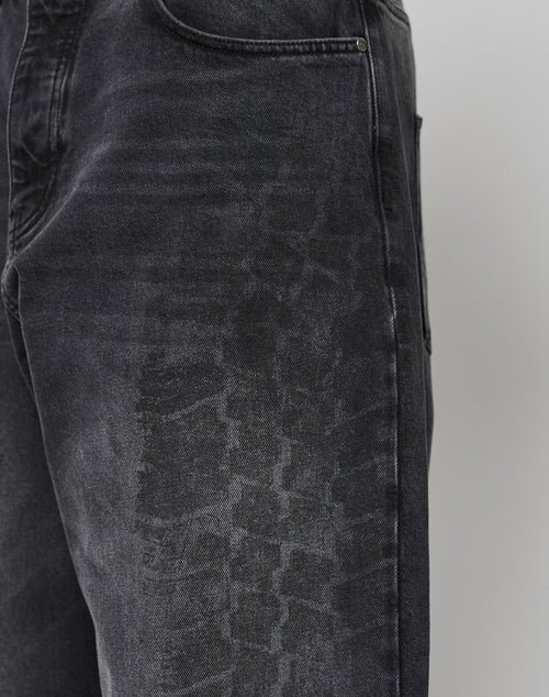 Close-up of the LFDY Tire Tracks Denim by LIVE FAST DIE YOUNG, featuring a baggy fit and a faded, textured pattern resembling tire tracks on the thigh near the front pocket for added comfort and style.
