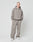 A person wearing the LIVE FAST DIE YOUNG Basic Blank Hooded in an oversize fit with matching gray Baumwolle-Polyester pants and white sneakers stands with hands in pockets against a plain light background, expression neutral.