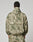 A person stands facing away, wearing the LIVE FAST DIE YOUNG Live Fast Nylon Jacket in light green and beige camo with a hood and matching pants, hands at their sides against a plain light background.