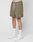 Wearing LIVE FAST DIE YOUNG Basic Mesh Shorts in olive green with an elastic waistband and logo patch, paired with a white LIVE FAST waistband, white socks, and sneakers. Only the lower half is shown against a plain white background.
