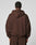 A person with short, curly hair is seen from behind wearing the LIVE FAST DIE YOUNG LFDY Pleated Hooded Zip in dark brown against a light grey background.