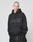 A person with a shaved head wears the LIVE FAST DIE YOUNG Basic Hooded in black with hands in the pocket, standing against a plain light background.
