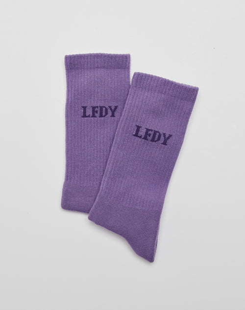 A pair of LIVE FAST DIE YOUNG LFDY Logo Socks (2 Pack) in purple, crafted from soft Baumwolle, featuring black LFDY logo print on top, displayed flat on a white surface.