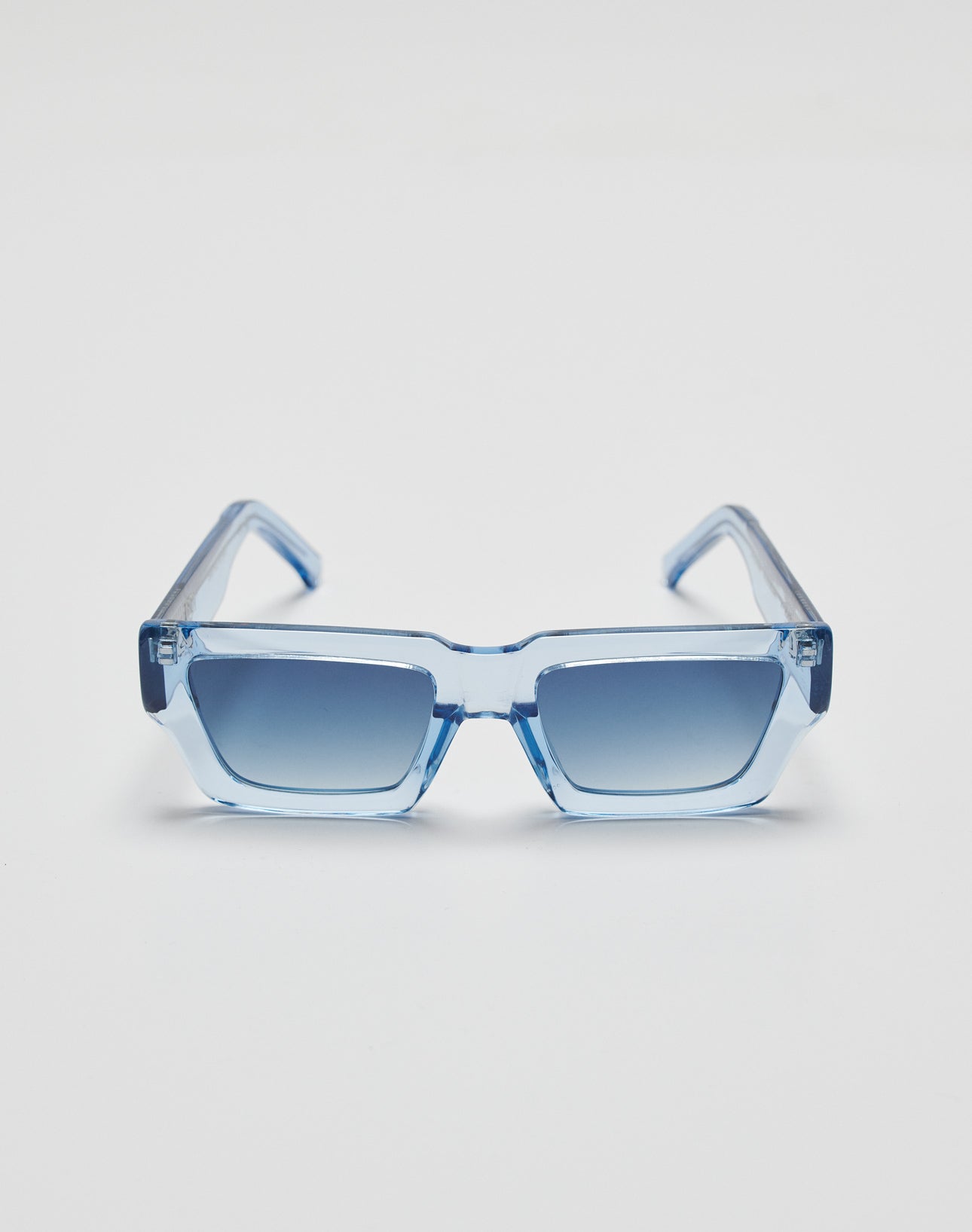 The Live Fast Sunglasses by LIVE FAST DIE YOUNG feature square translucent blue Mazzuchelli Acetate frames and blue gradient lenses with UV protection, shown against a plain white background.