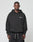 A man faces forward in a black LIVE FAST DIE YOUNG Basic 360 Hooded sweatshirt with “LiveFast” on the left chest and black athletic shorts, against a light gray background. Subtle topstitching adds detail to the casual look.