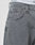 Close-up of a person wearing LFDY Baggy Denim jeans by LIVE FAST DIE YOUNG in light gray with baggy fit, straight leg, small front pocket, belt loops, silver D-ring, and white underwear waistband with black text peeking above.