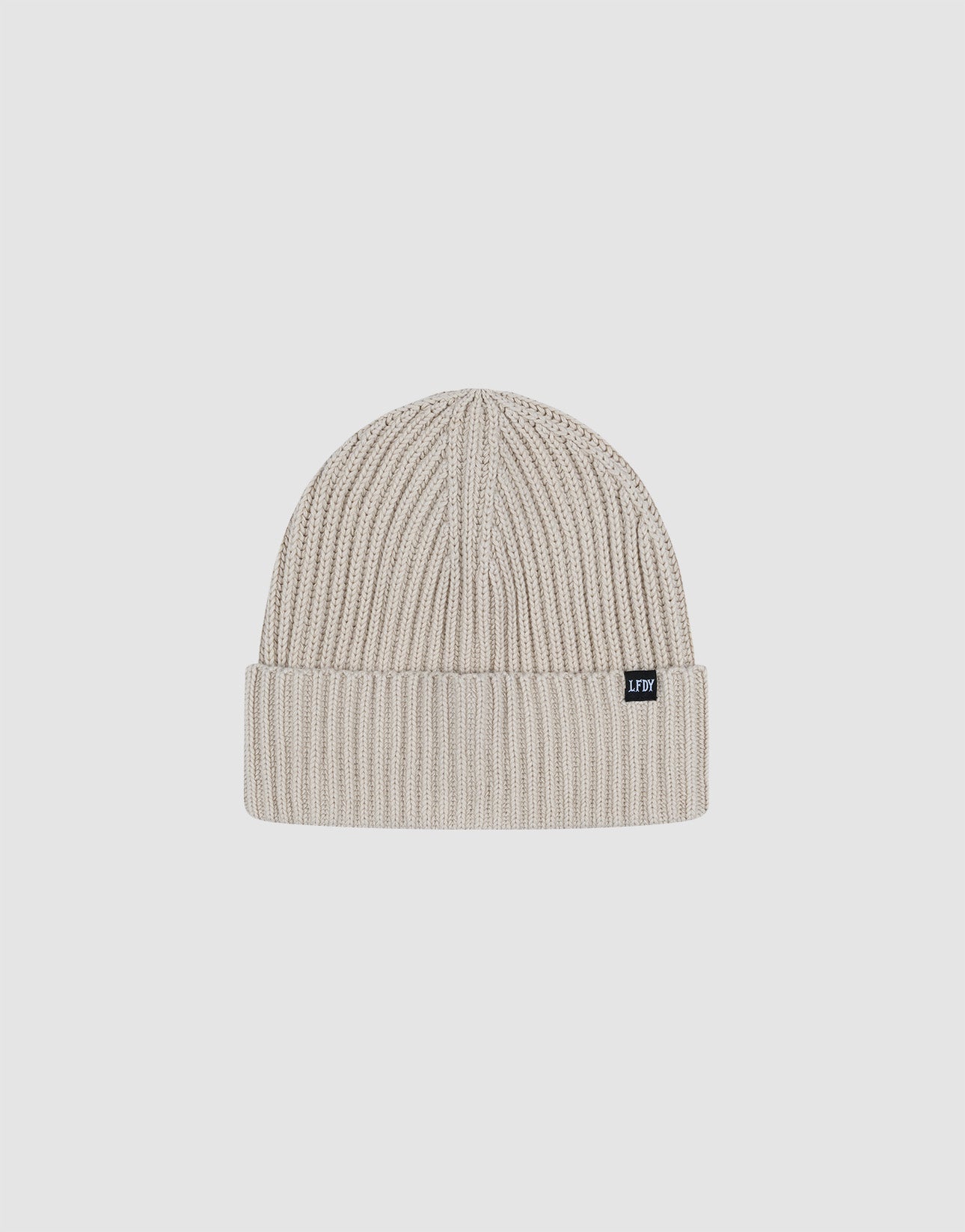 The LIVE FAST DIE YOUNG Washed Rib Knit Beanie is a light grey, one-size ribbed knit with a folded cuff and small black flag-label, made from soft polyamide, shown against a plain white background.
