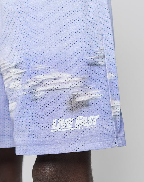 A close-up of LFDY Boat Mesh Shorts by LIVE FAST DIE YOUNG, featuring light purple polyester mesh, a blurred graphic, and LIVE FAST in white near the hem. Regular fit offers comfort and style.