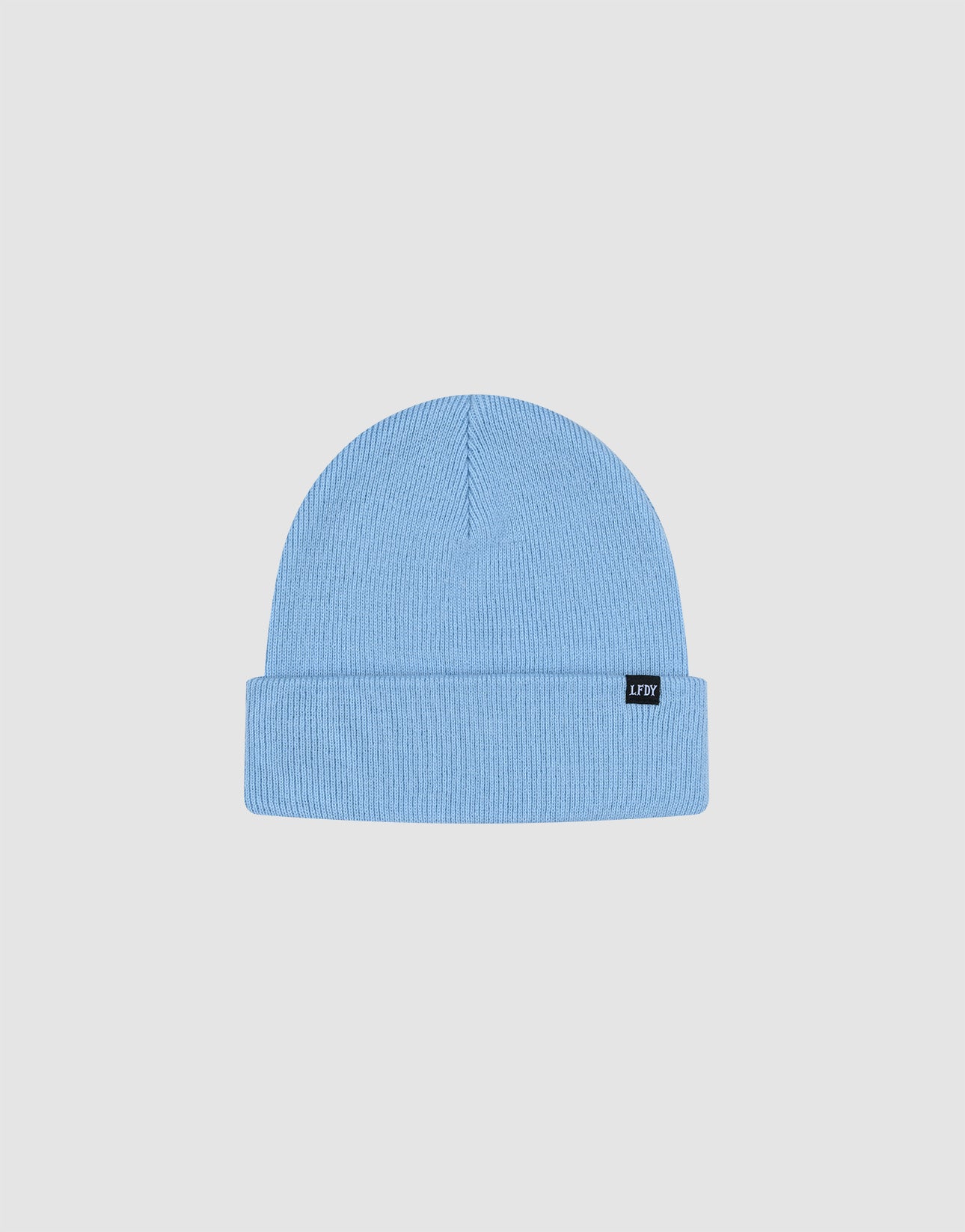 The LIVE FAST DIE YOUNG Basic Beanie in light blue, One Size, features a folded brim and small black flag-label on the cuff. Made from soft polyamide. Displayed against a plain white background.
