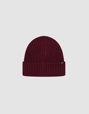 The LIVE FAST DIE YOUNG Rib Knit Beanie in maroon features a ribbed knit design, folded cuff, and small black Flag-Label tag on the cuff, shown against a plain light grey background.