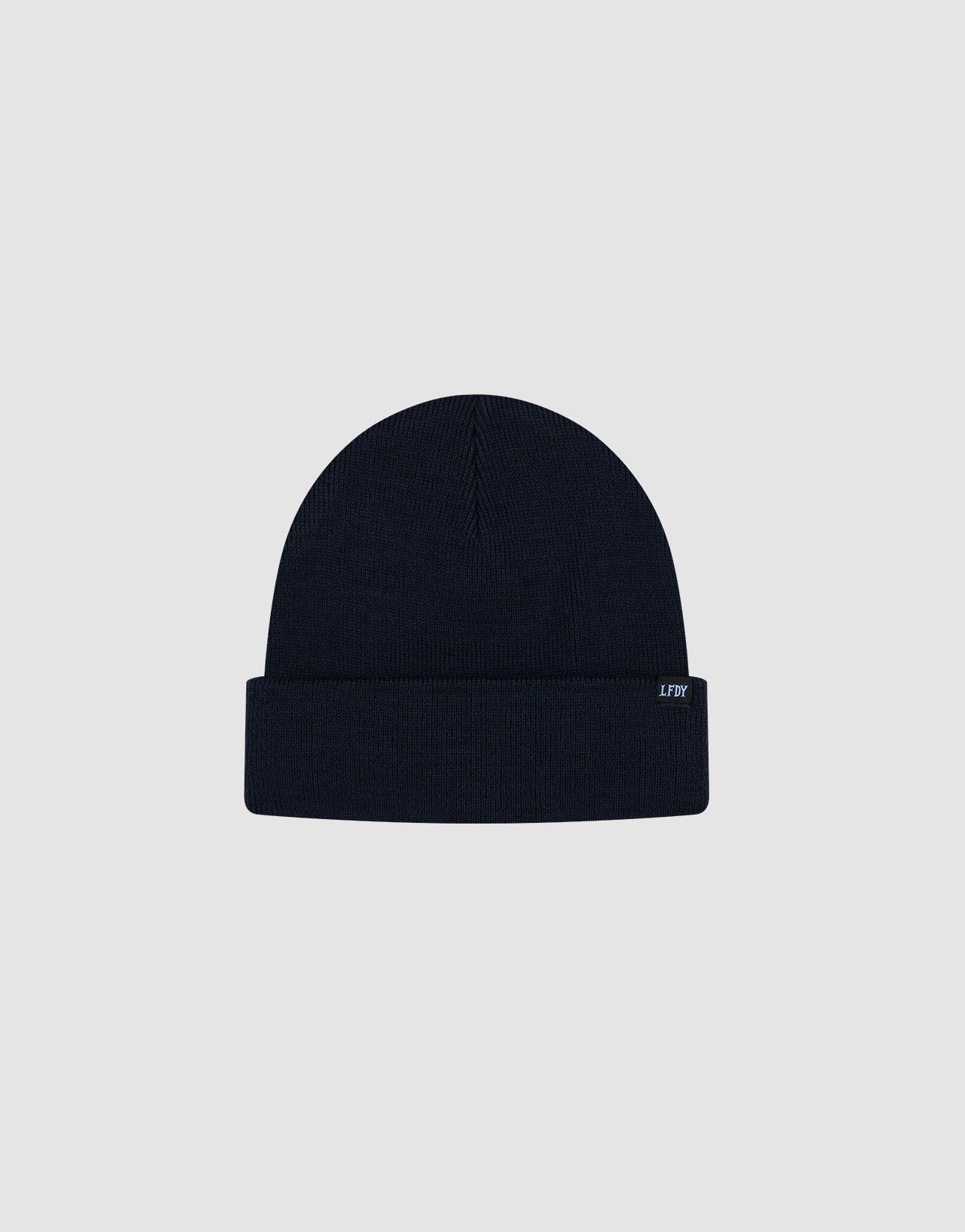 The LIVE FAST DIE YOUNG Basic Beanie is a plain, dark navy knit with a folded brim and a small rectangular flag-label featuring subtle text, shown against a light grey background.