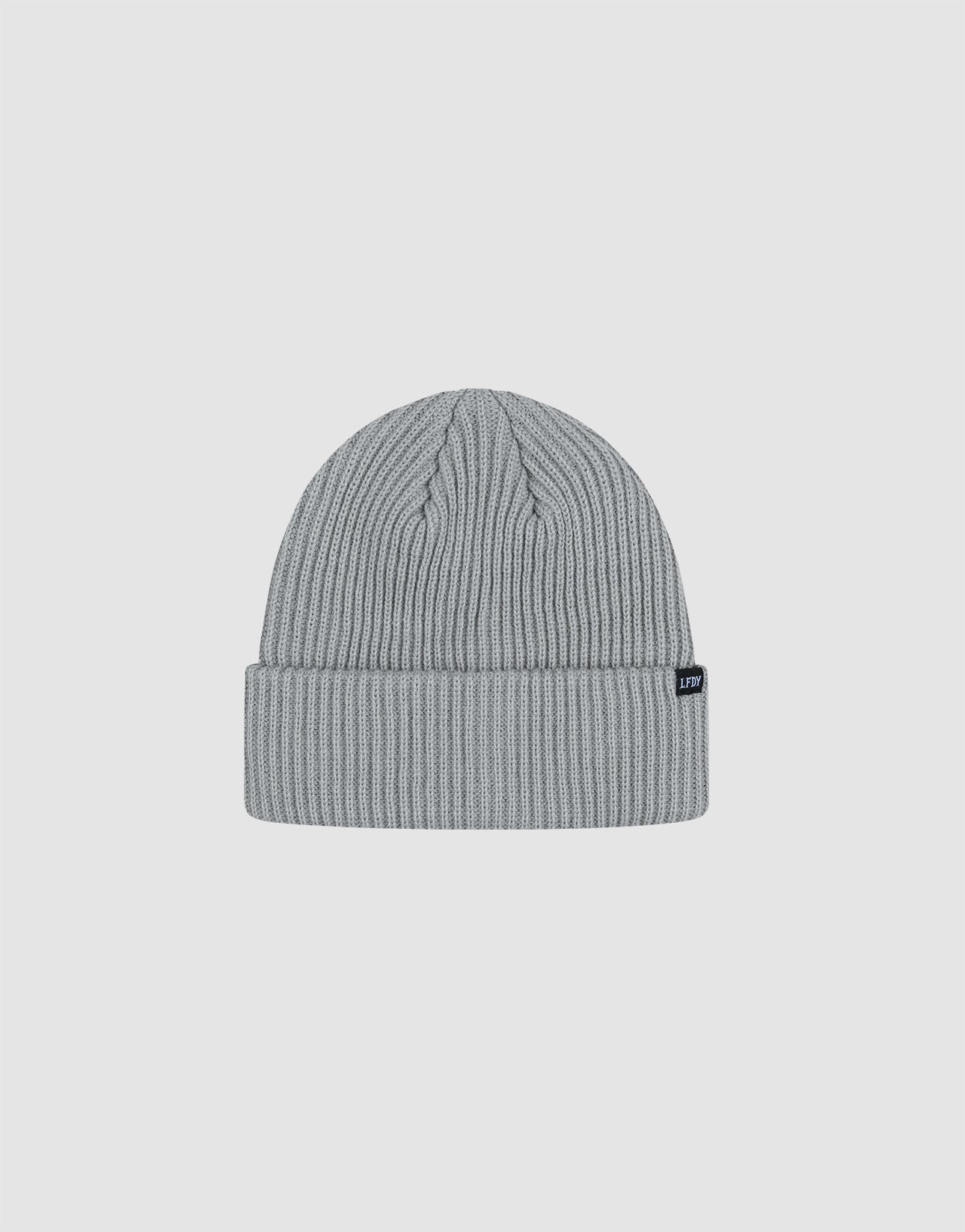 The LIVE FAST DIE YOUNG Rib Knit Beanie in light gray polyacryl features a folded cuff with a small black tag, shown on a white background. This stylish one-size beanie offers cozy comfort and modern flair.