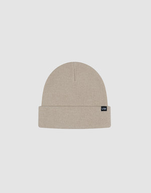 A beige Basic Beanie by LIVE FAST DIE YOUNG, crafted from soft polyamide with a folded brim and a small black LIFON flag-label, displayed on a plain light grey background.