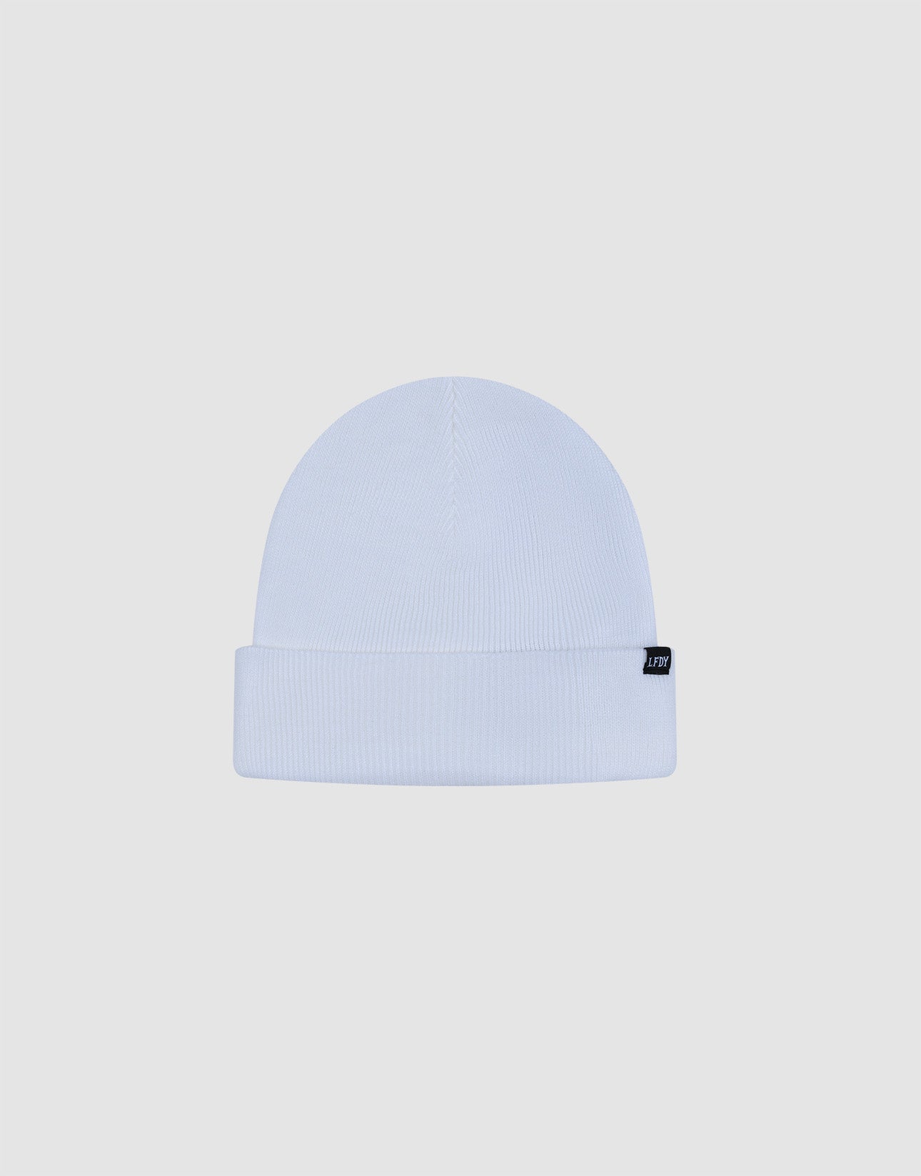 The LIVE FAST DIE YOUNG Basic Beanie is a plain white knit, One Size, with a folded brim and a small black rectangular flag-label on the side, displayed against a light gray background.