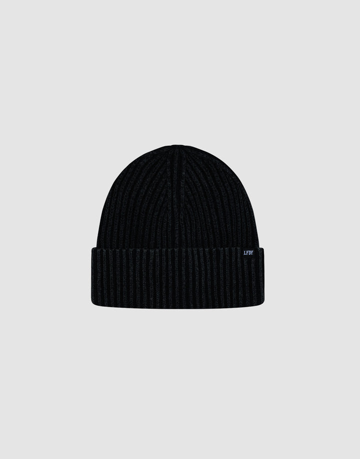 A black LFDY Rib Knit Beanie made from soft polyacryl with a folded brim and a small side tag, shown against a plain light gray background.