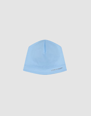 The Live Fast Performance Beanie by LIVE FAST DIE YOUNG features a light blue fitted design with "LIVE FAST" in small gray text near the edge, shown against a plain white background.