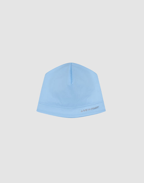 The Live Fast Performance Beanie by LIVE FAST DIE YOUNG features a light blue fitted design with "LIVE FAST" in small gray text near the edge, shown against a plain white background.