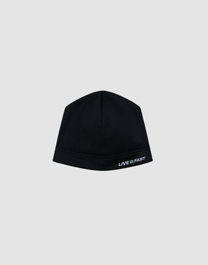 The Live Fast Performance Beanie by LIVE FAST DIE YOUNG is a fitted black beanie with a thin fleece lining and "LIVE FAST" in white on the lower right, shown against a plain light gray background.