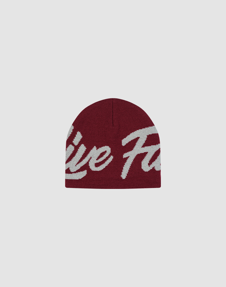 The LFDY Jacquard Beanie by LIVE FAST DIE YOUNG is a maroon polyamide knit hat with bold white Logo Strick script lettering across the front, shown on a plain light gray background.