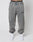 A person wears the LIVE FAST DIE YOUNG LFDY Europe Run Jogger—loose-fitting, faded gray sweatpants with LIVE FAST on the left thigh, Vintage Waschung, and elasticized waistband and cuffs—paired with white sneakers against a white background.
