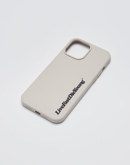 A beige Basic Phone Case by LIVE FAST DIE YOUNG rests on a white surface, featuring the bold LiveFastDieYoung logo near the bottom right for a sleek, statement look.