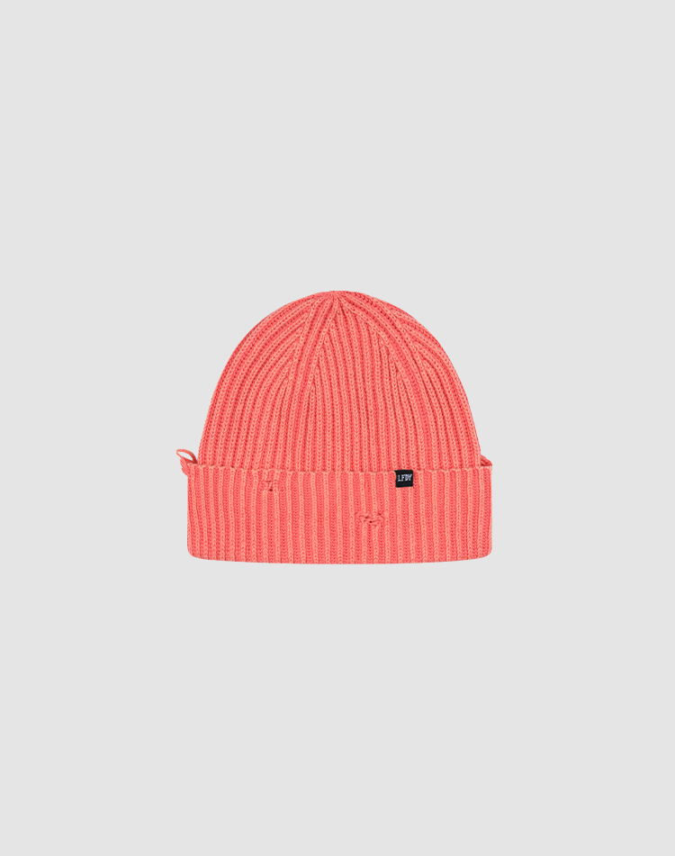 The LIVE FAST DIE YOUNG Distressed Rib Knit Beanie is a bright pink 100% Baumwolle hat with a folded brim and small black side tag, shown on a plain light gray background. 