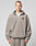A person with short hair wears the LIVE FAST DIE YOUNG Live Fast Fleece Halfzip, a loose, light gray fleece half-zip pullover with an oversized fit and small left chest logo, standing against a plain light background.