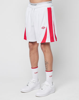 A person wears LIVE FAST DIE YOUNG Striped Mesh Shorts with a white waistband, red accents, a logo patch, white crew socks featuring red LEDI text, and white sneakers, standing against a plain white background.