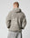 Seen from behind, a person with short hair wears the Live Fast Teddy Jacket by LIVE FAST DIE YOUNG, featuring an oversize fit, hood, and large embossed LIVE FAST branding on the back. They style it casually with light-wash jeans.