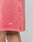 A close-up of a person wearing LIVE FAST DIE YOUNG Basic Sweat Shorts in pink, featuring an elastic waistband and a white LFDY™ logo near the hem. Only part of the leg and the subtly faded lower shorts are visible.