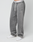 Person wearing LIVE FAST DIE YOUNG Basic Wide Jogger in gray with an oversized fit and white drawstrings, paired with white sneakers. Only the body from the waist down is visible. LIVE FAST logo is printed on the waistband.