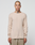 A person with a shaved head and visible neck tattoo stands facing forward, wearing the LIVE FAST DIE YOUNG Basic Regular Rib Longsleeve in beige and regular-fit light brown pants against a plain white background.