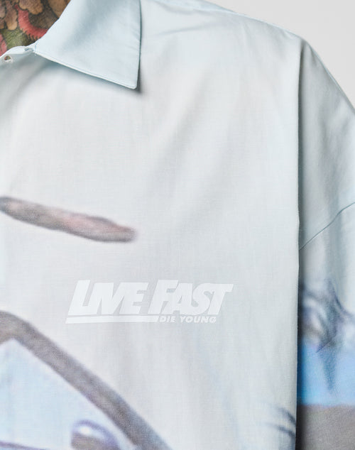 Close-up of the LFDY Crash Kid Shirt by LIVE FAST DIE YOUNG, an oversize fit with white LIVE FAST DIE YOUNG chest print, partial blurred graphic, classic collar, and bold logo details for a striking style.
