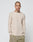 A person with a shaved head and neck tattoos wears the LIVE FAST DIE YOUNG Basic Regular Rib Longsleeve in beige and light brown drawstring pants, standing against a plain background with hands in pockets.
