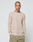 A person with a shaved head and neck tattoos stands against a white background, wearing the LIVE FAST DIE YOUNG Basic Regular Rib Longsleeve in beige with light brown drawstring pants for a comfortable regular fit look.