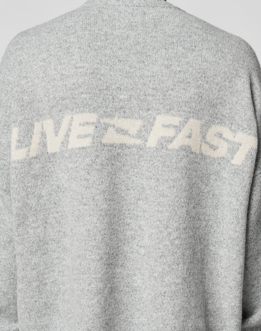 The Live Fast Boucle Sweater by LIVE FAST DIE YOUNG is a gray, 100% polyester piece with an oversize fit and bold white LIVE FAST lettering across the upper back.